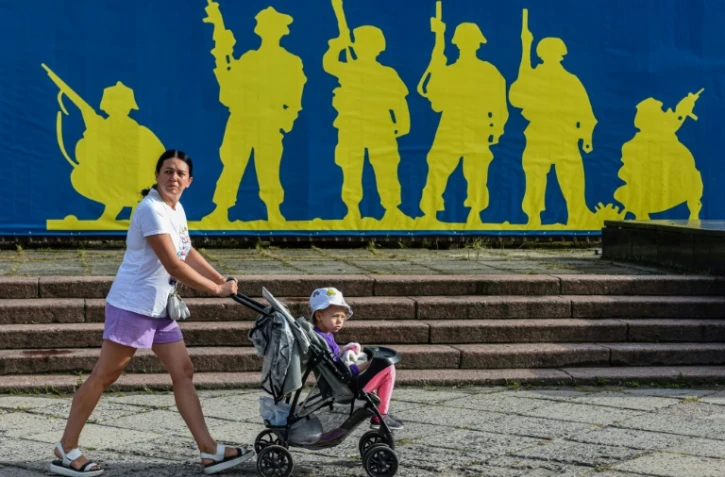 Une femme et un enfant le Jour du drapeau national en Ukraine, à Lviv (ouest), le 23 août 2022