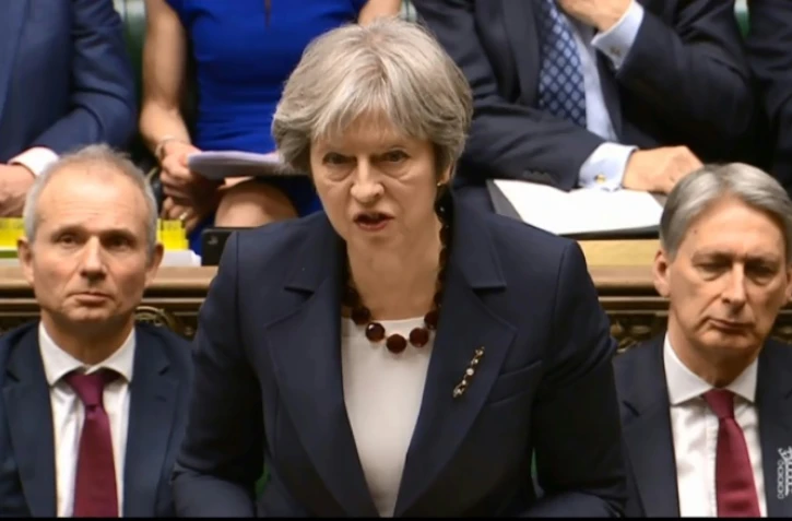 Capture d'écran d'une vidéo fournie par la Parlementary recording unit (PRU) de Theresa May devant le parlement britannique à Londres, le 14 mars 2018