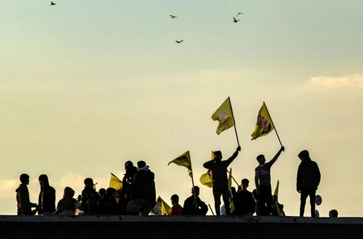 Des Kurdes syriens brandissent des drapeaux avec le portrait du fondateur du PKK, Abdullah Ocalan, le 27 février 2025, à Qamishli, en Syrie