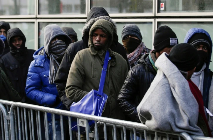Des migrants en file d'attente devant la "plate-forme d'accueil des réfugies" (PADA) boulevard de la Villette, le 26 janvier 2017 à Paris