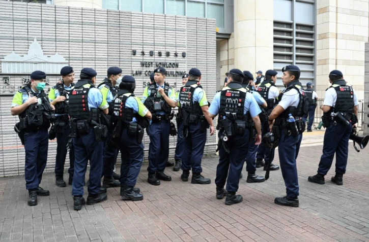 Des policiers sont rassemblés à l'extérieur du tribunal où 14 militants prodémocratie ont été reconnus coupables de subversion, le 30 mai 2024 à Hong Kong