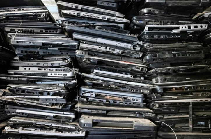 De vieux d'ordinateurs portables empilés sur des étagères dans l'atelier local de l'ONG Electronic Waste Initiative Kenya (E-WIK) à Nairobi, le 3 décembre 2021