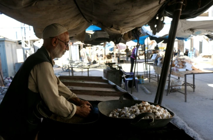 Un homme vend de l'ail sur un marché déserté à Alep, en Syrie, le 8 septembre 2016