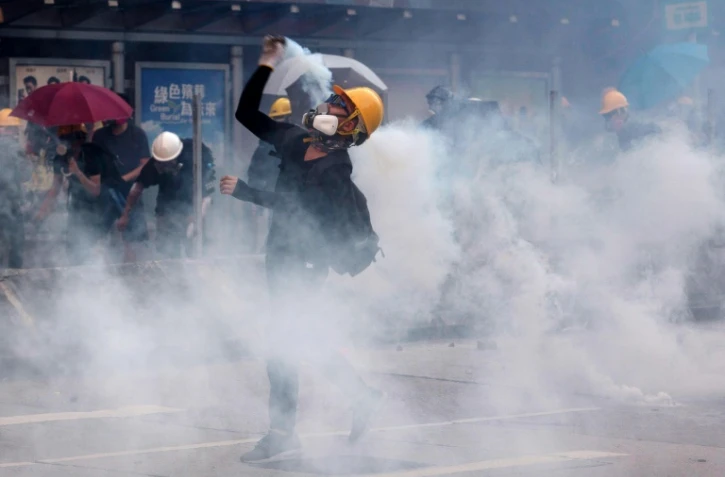 Un manifestant renvoie vers les forces de l'ordre une canette de gaz lacrymogène, le 5 août 2019 à Hong Kong