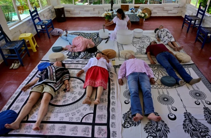 Alizbeth Camacho (c) dirige une séance de méditation au centre holistique "Luz azul" ("Lumière bleue"), le 6 août 2022 à Tepoztlan, au Mexique