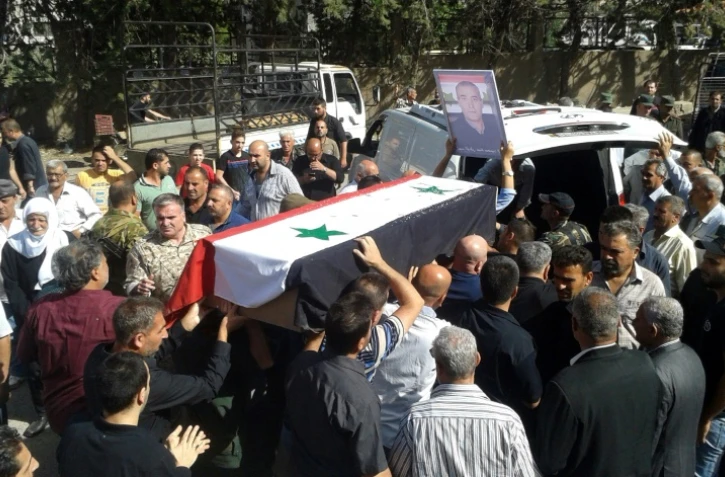 Photo diffusée le 26 juillet 2018 par l'agence de presse syrienne Sana montrant les funérailles de l'une des victimes des attaques commises le 25 juillet 2018 par l'EI dans la ville de Soueida, dans le sud de la Syrie