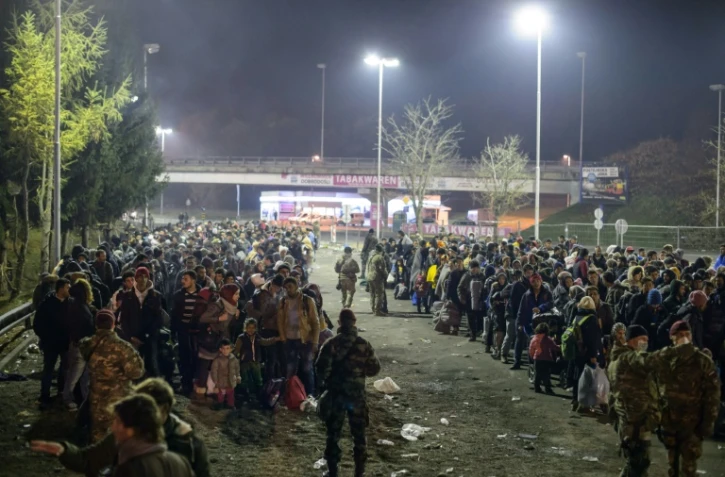 Des migrants attendent de traverser la frontière entre la Slovénie et l'Autriche depuis la ville slovène de Sentilj le 6 novembre 2015