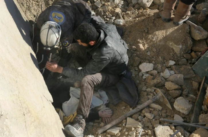 Des secouristes syriens extraient une victime d'un bombardement de décombres à Alep, le 4 février 2016