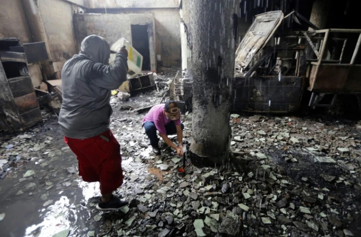A l'intérieur de la maison incendiée d'une famille dont six membres ont péri à Managua, le 16 juin 2018