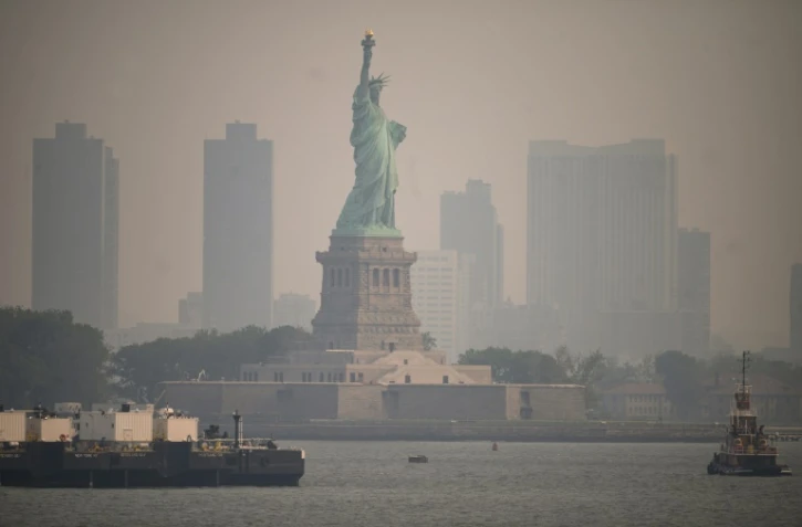 The Statue of Liberty from the Staten Island Ferry during heavy smog in New York on June 6, 2023