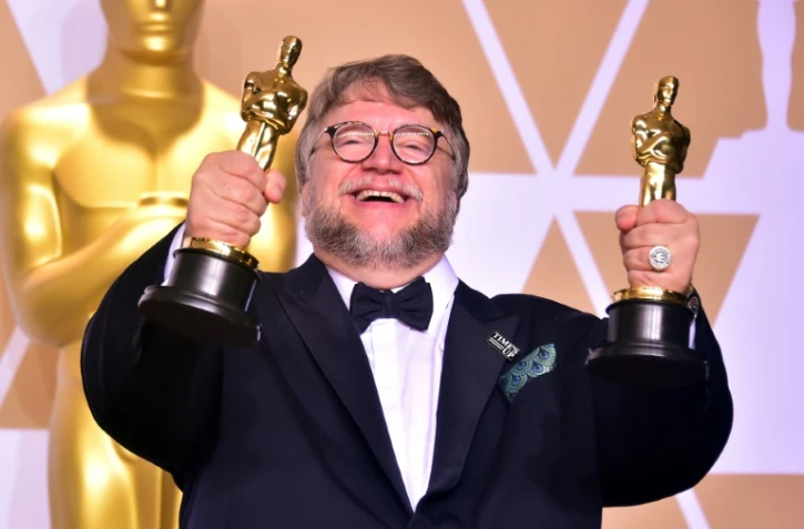 Le réalisateur mexicain Guillermo del Toro brandit ses deux Oscars de meilleur réalisateur et de meilleur film pour "La Forme de l'eau", le 4 mars 2018 à Hollywood