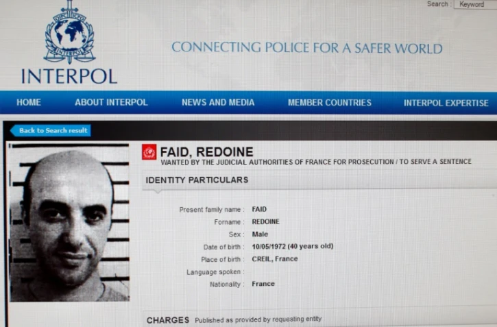  Une reproduction du site d'Interpol montrant la fiche de recherche du braqueur français Redoine Faïd, échappé de sa prison de Réau (Seine-et-Marne) le 1er juillet 2018