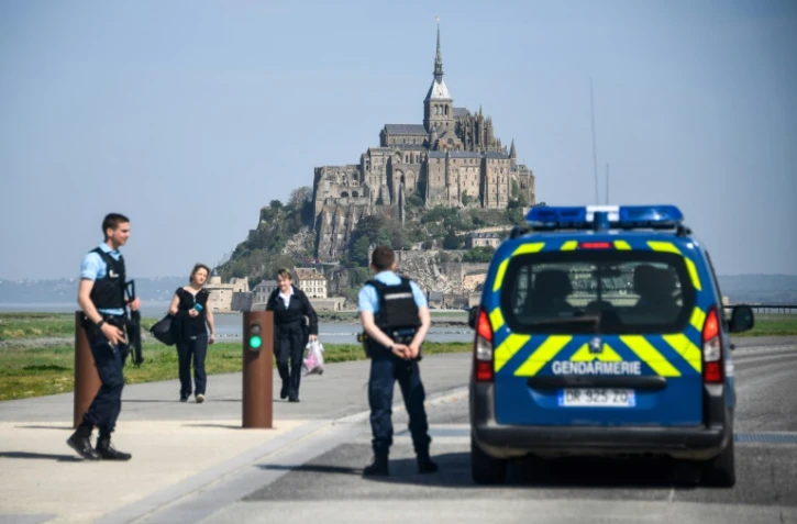 Des touristes et des gendarmes sur la route d'accès au Mont-Saint-Michel évacué par précaution après qu'un homme eut proféré des menaces contre les forces de l'ordre le 22 avril 2018