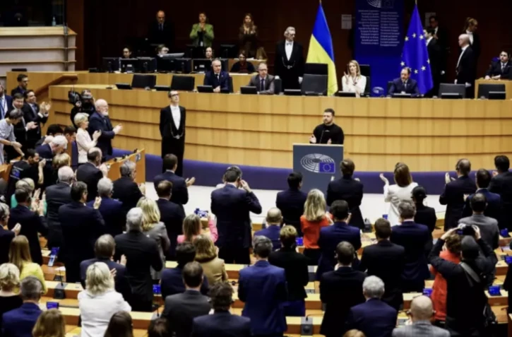 Le président ukrainien Volodymyr Zelensky applaudi par les parlementaires européens, le 9 février 2023 à Bruxelles ( AFP / Kenzo TRIBOUILLARD )